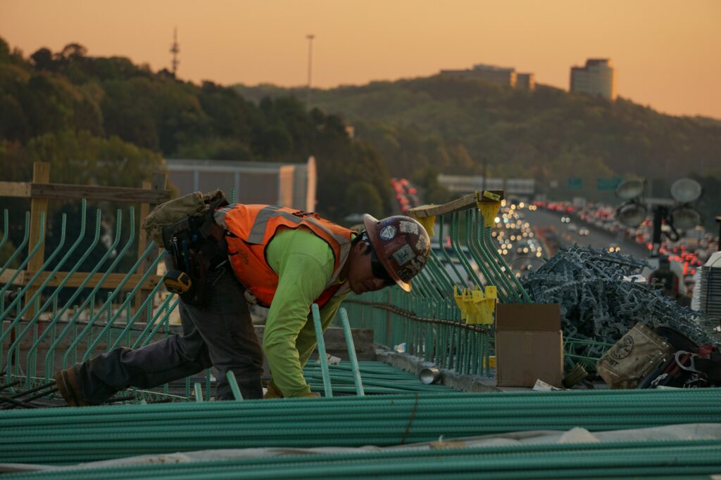 A man working safely on a bridge.