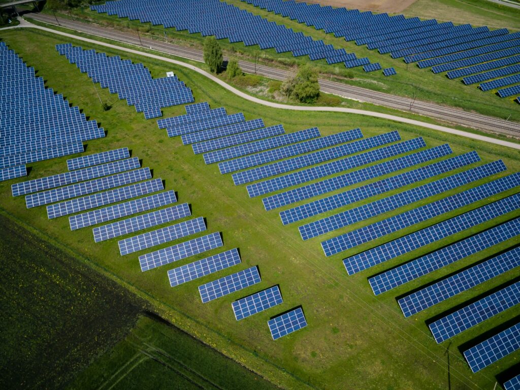 An aerial view of solar panels in a field, showcasing the renewable energy trend of solar power in the Australian context.